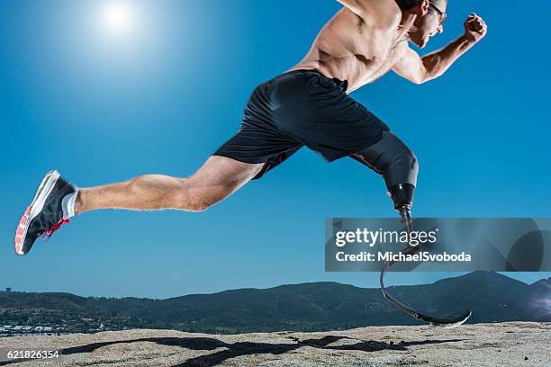 low angle of prosthetic leg running - amputee running stock pictures, royalty-free photos & images