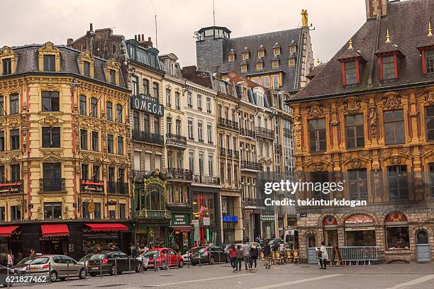 people at street with historical gothic buildings at lille france - lille france stock pictures, royalty-free photos & images
