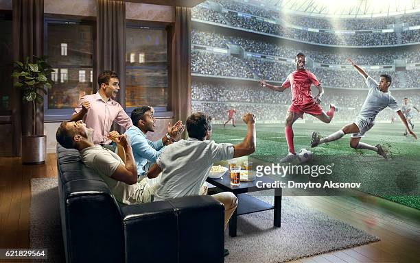 students watching very realistic soccer game on tv - fan enthusiast stock pictures, royalty-free photos & images