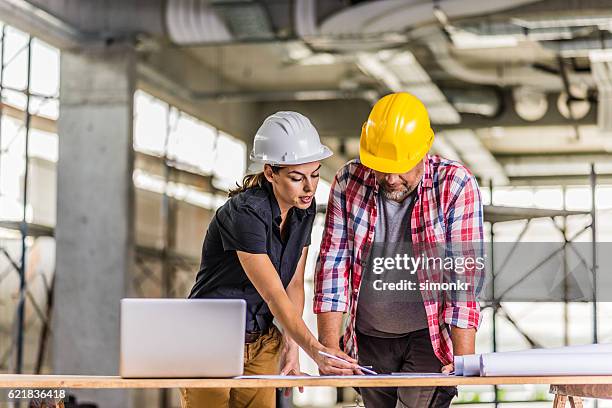 discussing on blueprint - fully unbuttoned stock pictures, royalty-free photos & images
