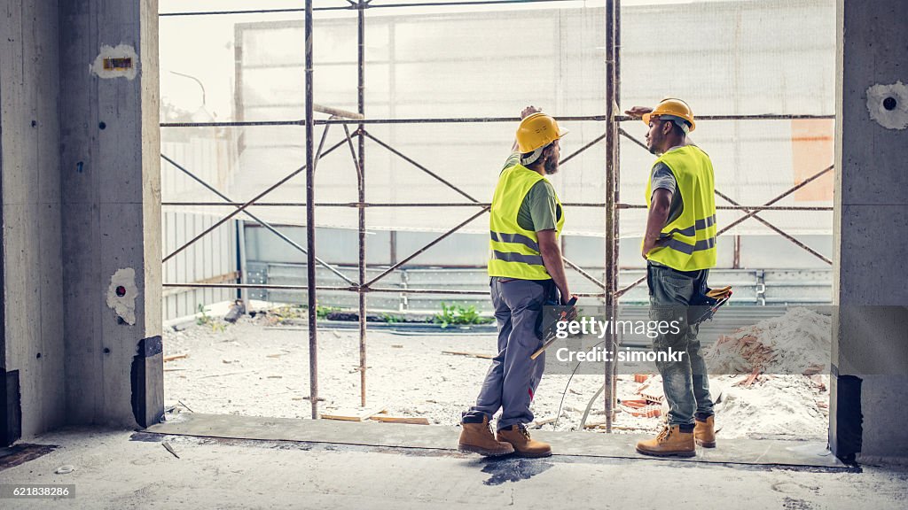 Construction workers discussing