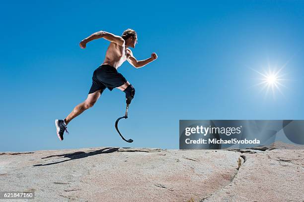 low angle of prosthetic leg running - amputee running stock pictures, royalty-free photos & images