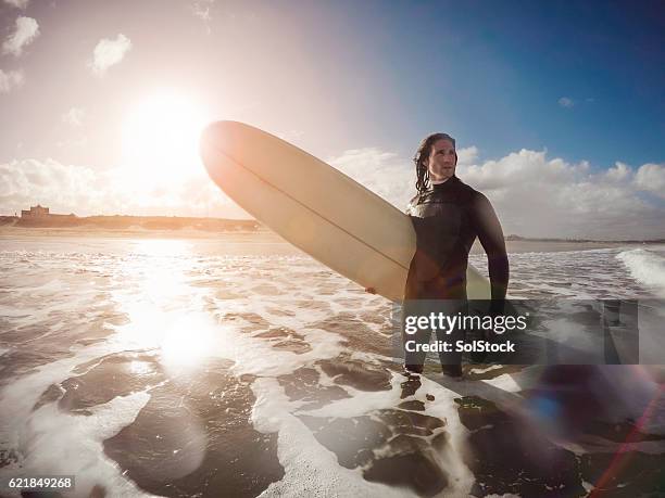 male surfer standing in the sea - ankle deep in water stock pictures, royalty-free photos & images