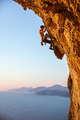 Rock climber on overhanging cliff