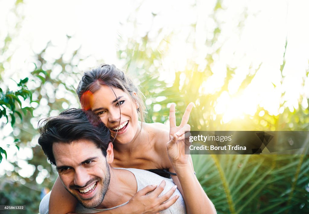 Young Couple Having Fun Piggyback Riding