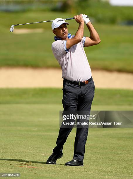 Jeev Milkha Singh of India plays a shot during practice for the Resorts World Manila Masters at Manila Southwoods Golf and Country Club on November...
