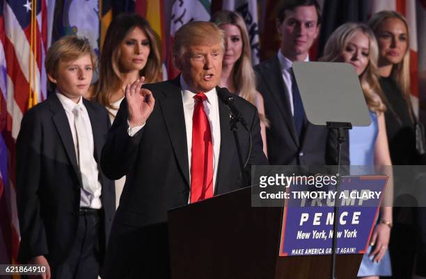 Republican presidential nominee Donald Trump arrives on stage with his family to speak to supporters during election night at the New York Hilton...