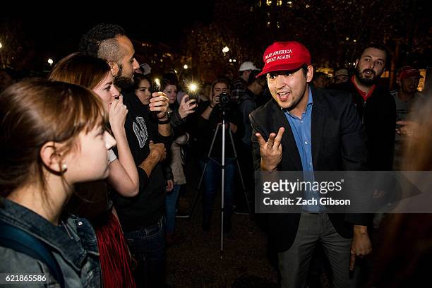 Donald Trump and Hillary Clinton supporters argue in front of The White House while waiting for 2016 election return updates on November 9, 2016 in...