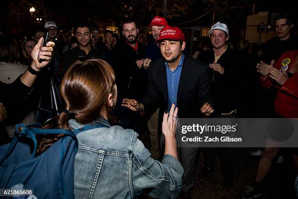 Donald Trump and Hillary Clinton supporters argue in front of The White House while waiting for 2016 election return updates on November 9, 2016 in...