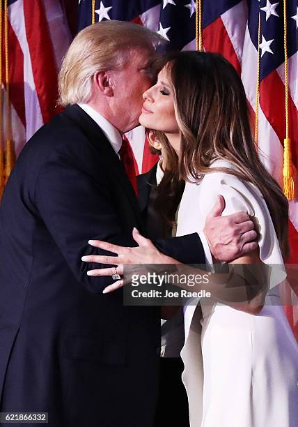 Republican president-elect Donald Trump embraces his wife Melania Trump during his election night event at the New York Hilton Midtown in the early...