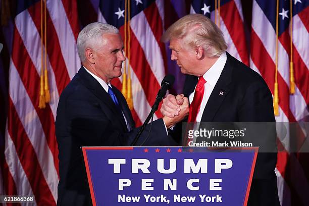 Vice president-elect Mike Pence and Republican president-elect Donald Trump shake hands during his election night event at the New York Hilton...