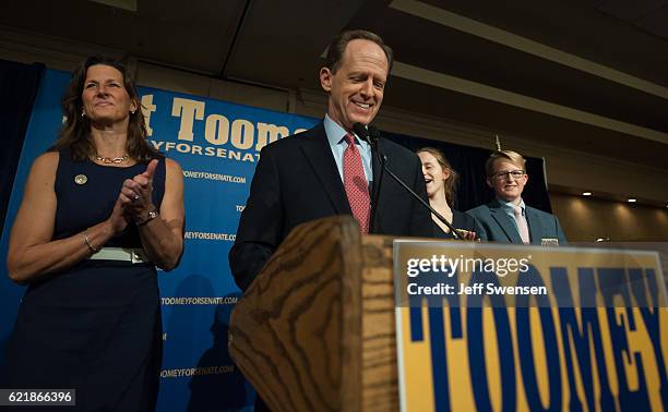 Senator Pat Toomey of Pennsylvania stands with his wife Kris Toomey as he prepares to speak to supporters following his election victory in a...