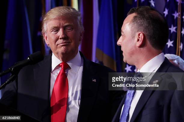 Republican president-elect Donald Trump and Reince Priebus, chairman of the Republican National Committee, look on during his election night event at...