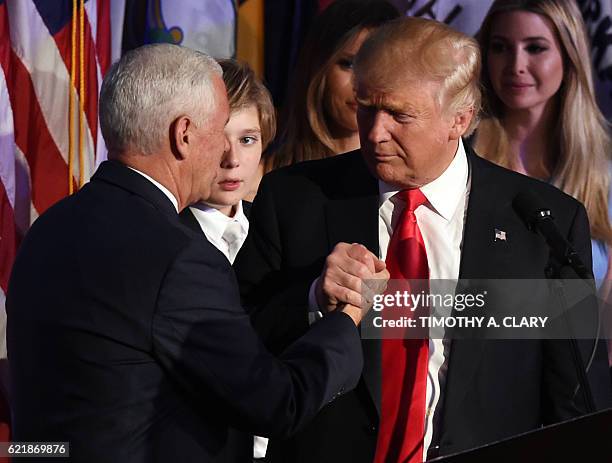 Republican presidential candidate Donald Trump shakes hands with his vice-president Mike Pence during an election night party at the New York Hilton...