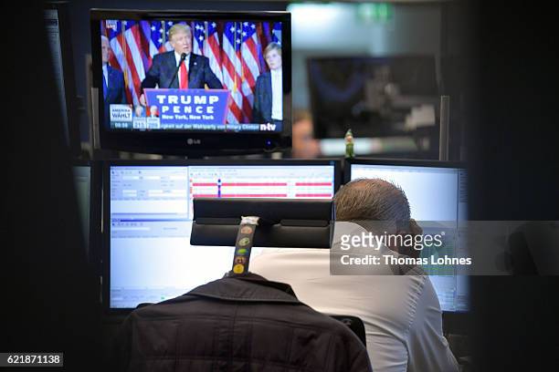 Trader reacts as he watch the speech of Donald Trump at the Frankfurt Stock Exchange on November 9, 2016 in Frankfurt, Germany. Stock markets around...