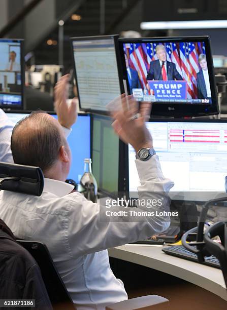 Trader reacts as he watch the speech of Donald Trump at the Frankfurt Stock Exchange on November 9, 2016 in Frankfurt, Germany. Stock markets around...