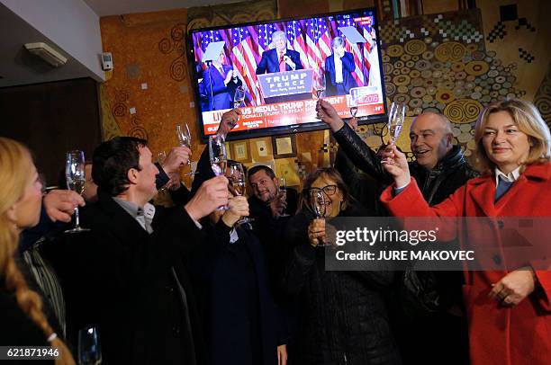 Residents of Sevnica, hometown of Melania Trump, wife of Republican presidential elect Donald Trump, raise glasses as they celebrate the victory of...