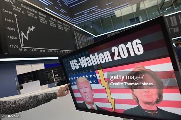 The candidates Donald Trump and Hillary Clinton of U.S. Presidential elections are seen on a TV screen below the graph showing the day's course of...