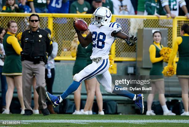 Jordan Todman of the Indianapolis Colts returns the opening kickoff for a touchdown in the first quarter against the Green Bay Packers at Lambeau...