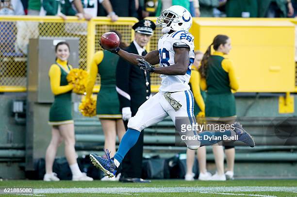 Jordan Todman of the Indianapolis Colts returns the opening kickoff for a touchdown in the first quarter against the Green Bay Packers at Lambeau...