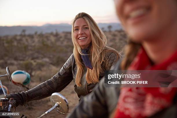 two young women on an adventure with motorcycles - selective focus imagens e fotografias de stock