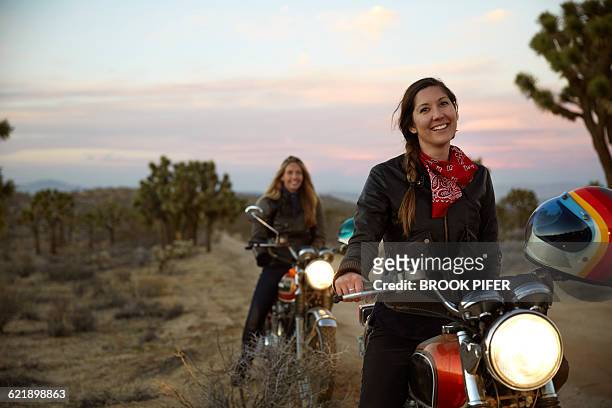 two young women on an adventure with motorcycles - vehicle light fotografías e imágenes de stock
