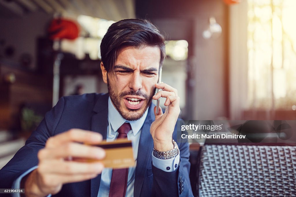 Furious man with empty credit card