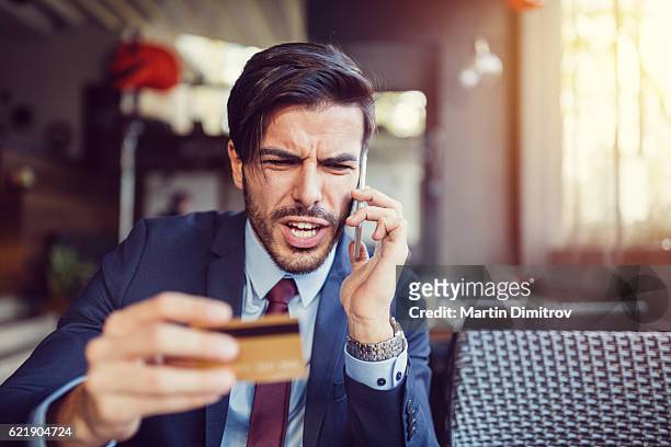 furious man with empty credit card - debit card fraud stock pictures, royalty-free photos & images