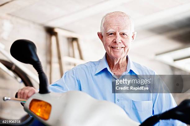 smiling 90-year-old man sits on his motor scooter - 85 2016 stock pictures, royalty-free photos & images