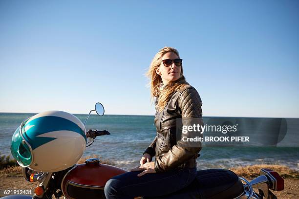 portrait of young woman with motorcycle - woman motorcycle stock pictures, royalty-free photos & images