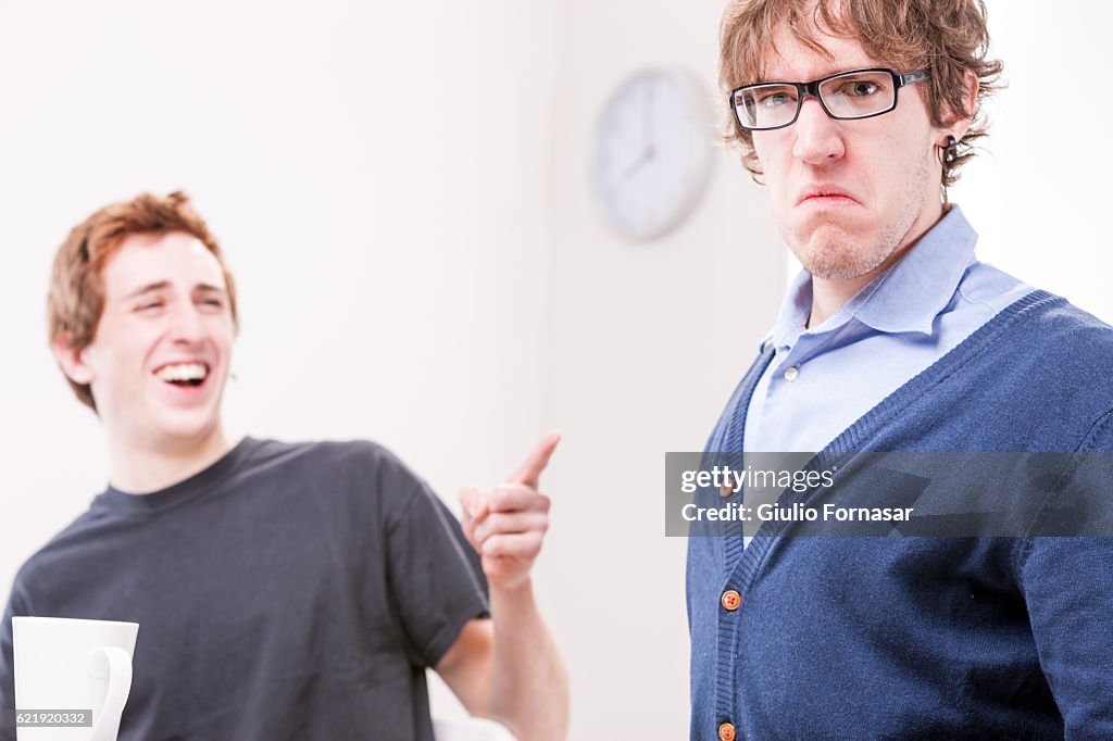 Office worker makin fun of his colleague