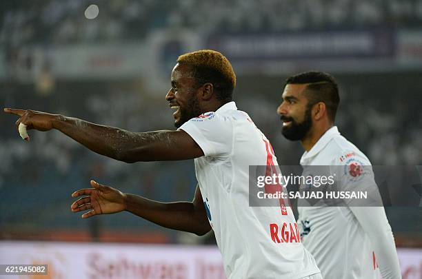 Delhi Dynamos FC forward Richard Gadze celebrates after scoring a goal against Chennaiyin FC during the Indian Super League football match between...