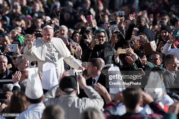 Pope Francis waves as he is driven through the crowd in St. Peter's Square for his weekly general audience, at the Vatican, Wednesday, Nov. 9, 2016.