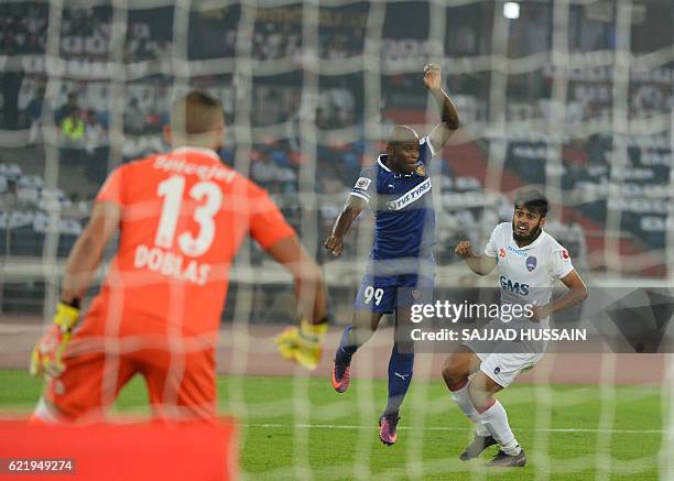 Delhi Dynamos FC defender Souvik Chakrabarti vies for the ball with Chennaiyin FC forward Dudu Omagbemi during the Indian Super League football match...