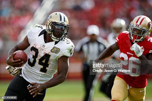 Running back Tim Hightower of the New Orleans Saints rushes up field past cornerback Tramaine Brock of the San Francisco 49ers during the second...