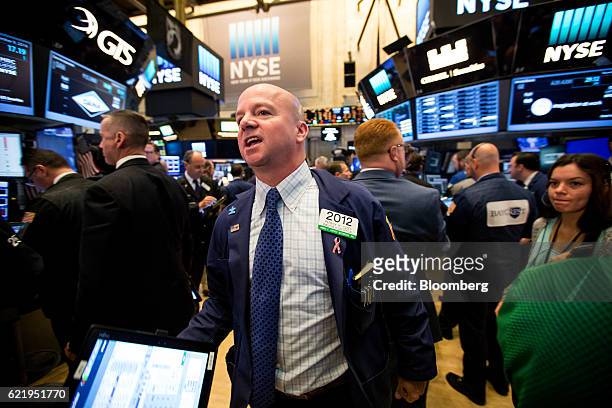 Trader works on the floor of the New York Stock Exchange in New York, U.S., on Wednesday, Nov. 9, 2016. U.S. Stocks fluctuated in volatile trading in...