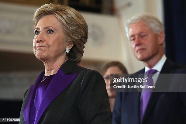 Former Secretary of State Hillary Clinton, accompanied by her husband former President Bill Clinton, pauses as she concedes the presidential election...