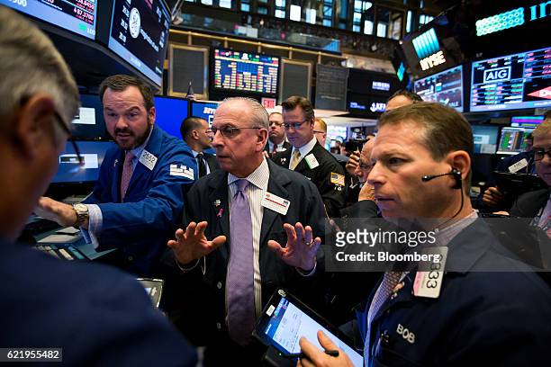 Traders work on the floor of the New York Stock Exchange in New York, U.S., on Wednesday, Nov. 9, 2016. U.S. Stocks fluctuated in volatile trading in...