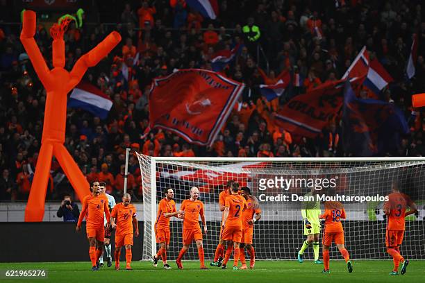 Davy Klaassen of the Netherlands celebrates with team mates as he scores their first goal from a penalty during the international friendly match...