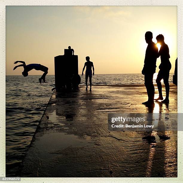 Young Libyan men jump into the sea from an concrete dock on July 9, 2012 in Benghazi, Libya.