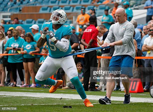 Mike Pouncey of the Miami Dolphins warms up prior to the game against the New York Jets on November 6, 2016 at Hard Rock Stadium in Miami Gardens,...