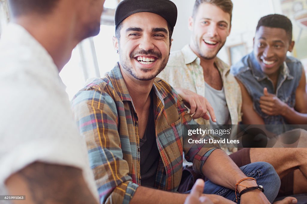 Friends laughing and relaxing indoors
