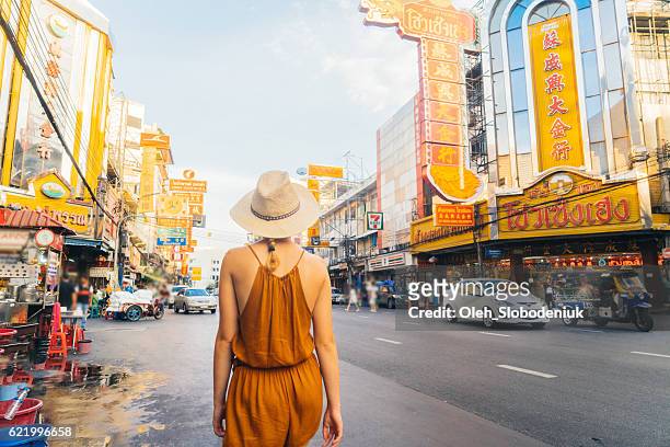 woman walking in chianatown - thailand city stock pictures, royalty-free photos & images