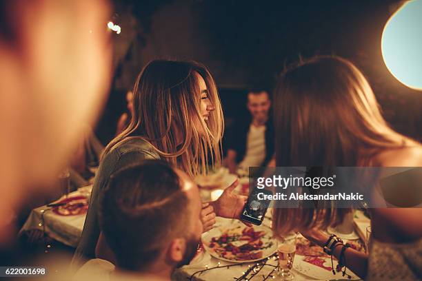 evening with friends in a bistro - evening meal stock pictures, royalty-free photos & images