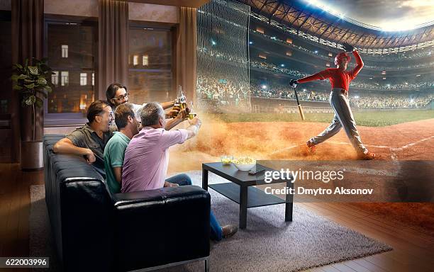 adults watching very realistic baseball game at home - baseball game stadium stockfoto's en -beelden