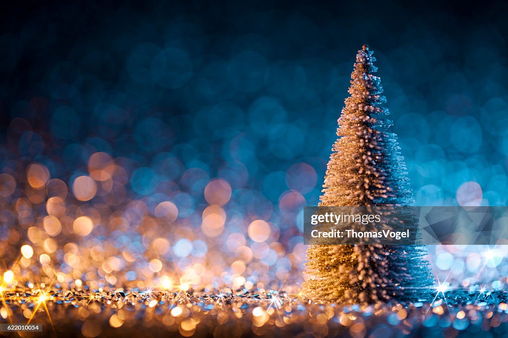 Christmas tree on defocused lights. Decorations Blue Gold