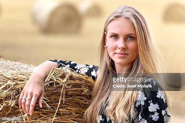 portrait of young blonde woman on field - josef mohyla stock pictures, royalty-free photos & images