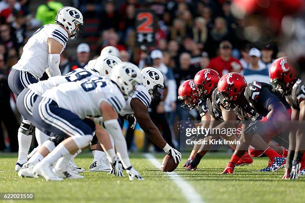 Tejan Koroma of the BYU Cougars prepares to snap the ball to Taysom Hill of the BYU Cougars during the game against the Cincinnati Bearcats at...