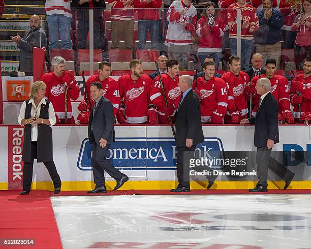 All four of former Detroit Red Wing Gordie Howe's children Cathy, Murray, Marty and Mark Howe walk out to center ice for the ceremonial puck drop in...