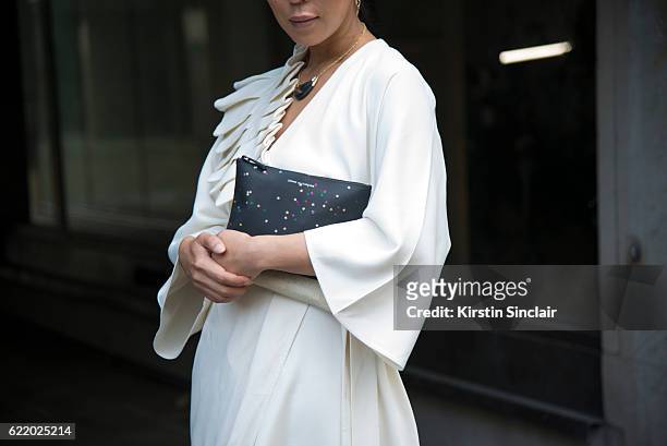 Fashion buyer and owner of the Satine Boutique Jeannie Lee wears an Osman Yousefzada dress, Comme des Garcons bag day 4 of London Womens Fashion Week...